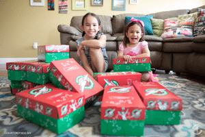 sisters fill shoeboxes in living room
